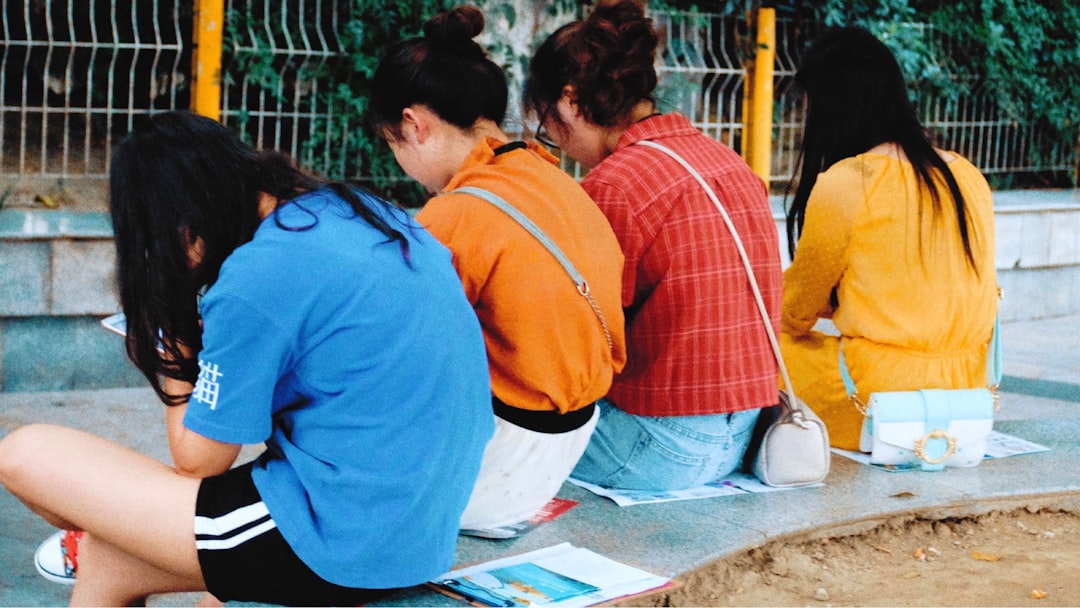 Group of college students collaborating around notebooks.