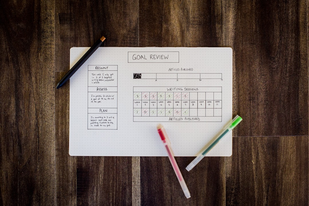 A planner with goals laid out on a minimal desk.